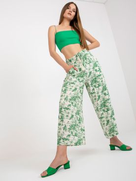 Smotanové rozšírené nohavice so zeleným vzorom